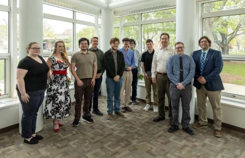 Students smiling with Optics faculty