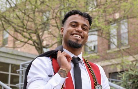 Ali with red Keene State commencement sash and stethoscope